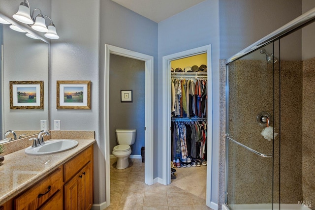 bathroom with vanity, an enclosed shower, tile patterned floors, and toilet