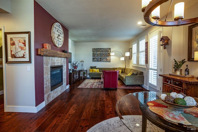 living room with a fireplace and dark hardwood / wood-style floors