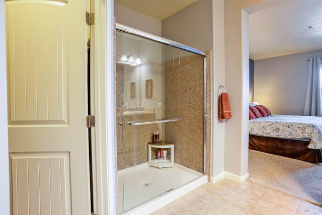 bathroom featuring an enclosed shower and tile patterned floors