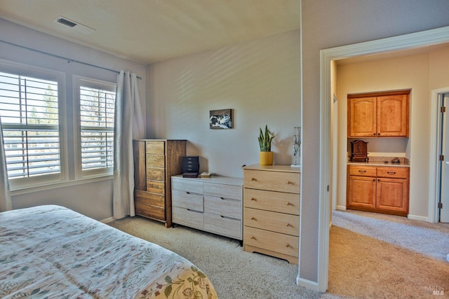 bedroom featuring light colored carpet