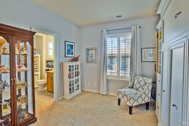 living area with a healthy amount of sunlight and light carpet