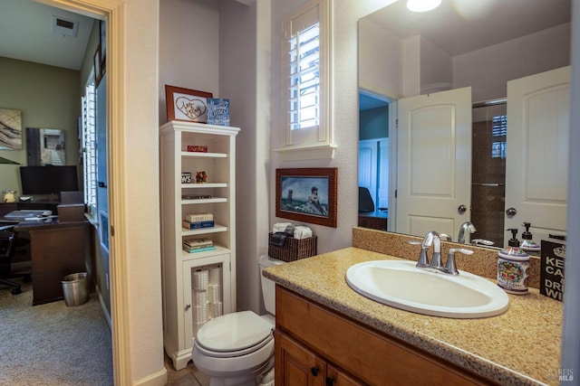 bathroom featuring vanity and toilet