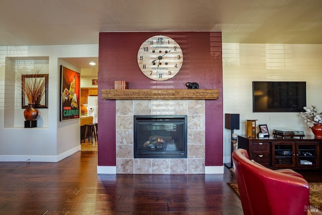 living room with a fireplace and dark hardwood / wood-style floors