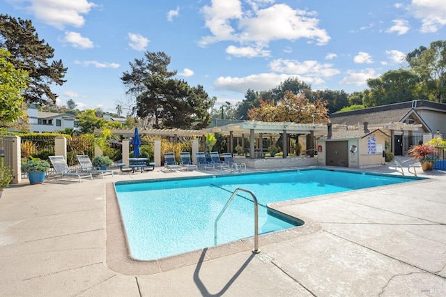 view of pool with a pergola and a patio area