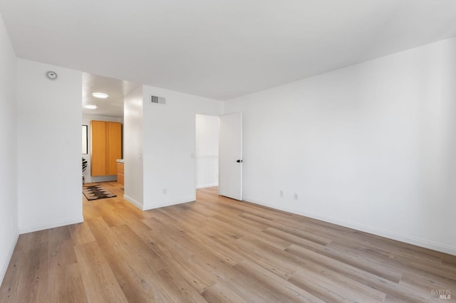 spare room featuring light wood-type flooring