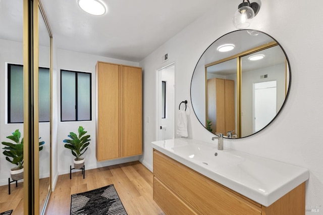 bathroom featuring vanity and hardwood / wood-style floors