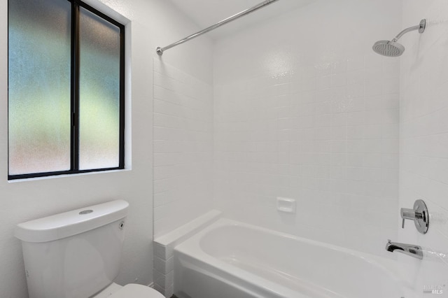 bathroom featuring bathing tub / shower combination and toilet