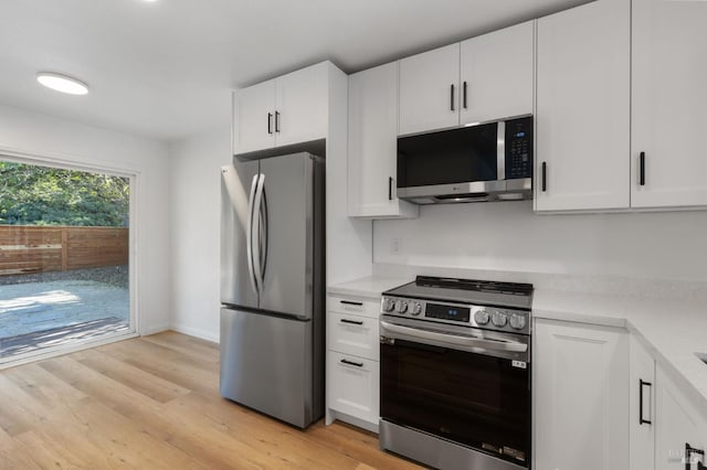 kitchen featuring white cabinetry, stainless steel appliances, and light hardwood / wood-style flooring