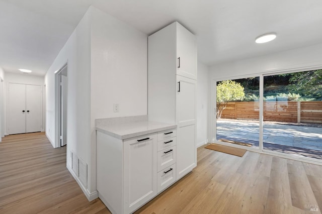 hallway with light hardwood / wood-style flooring