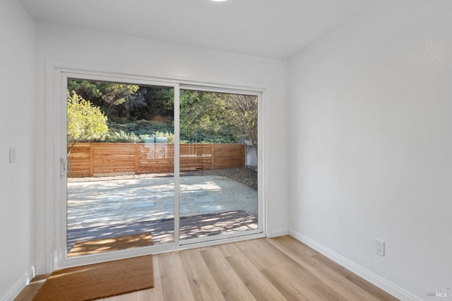 doorway to outside featuring plenty of natural light and light hardwood / wood-style floors