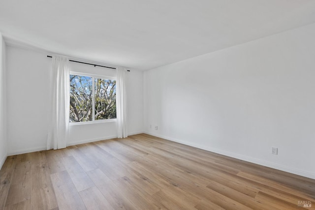 unfurnished room with light wood-type flooring