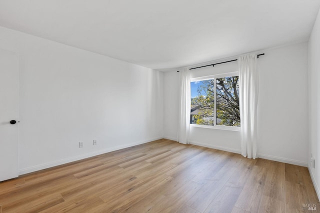 spare room featuring light hardwood / wood-style flooring