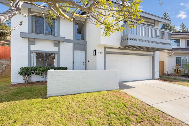 view of front facade with a balcony, a garage, and a front lawn