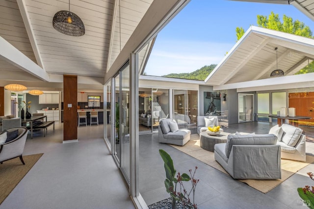 sunroom with lofted ceiling with beams and wooden ceiling