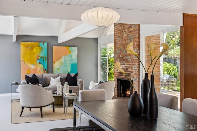 interior space with vaulted ceiling with beams, wood ceiling, and a fireplace