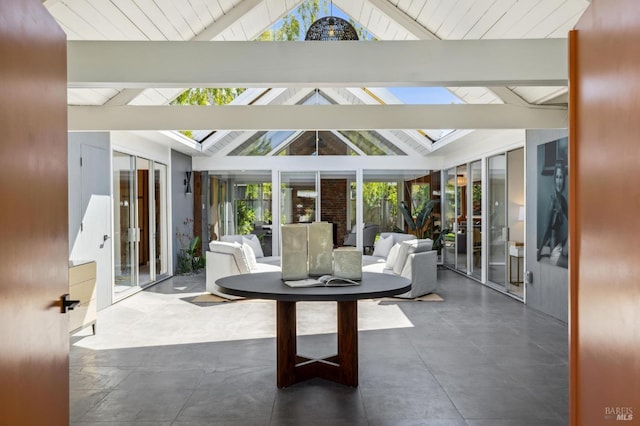 sunroom with vaulted ceiling with skylight