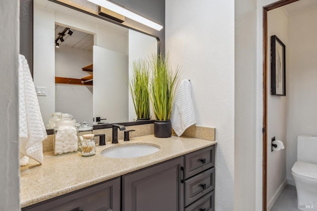 bathroom featuring toilet and vanity