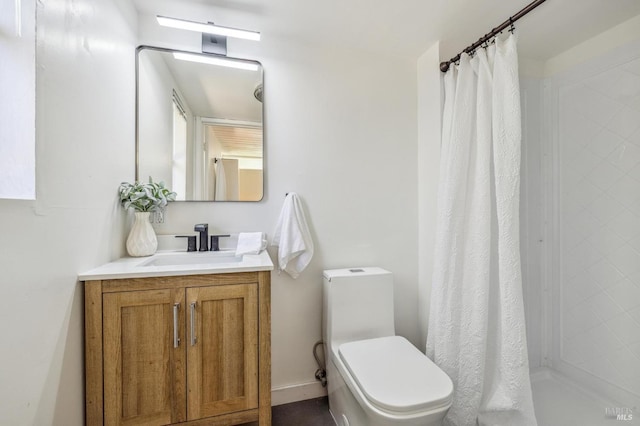 bathroom with a shower stall, vanity, and toilet