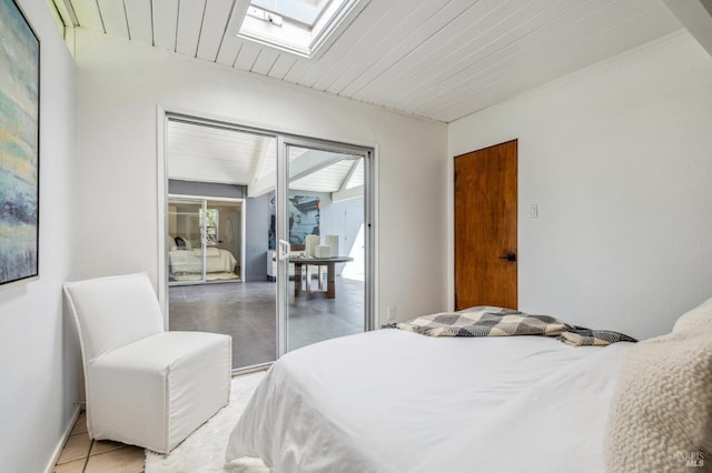 bedroom featuring a skylight, wood ceiling, and baseboards