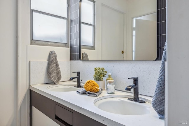 full bathroom featuring a sink and double vanity