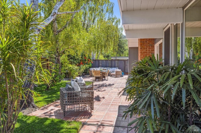 view of patio / terrace featuring fence and an outdoor hangout area