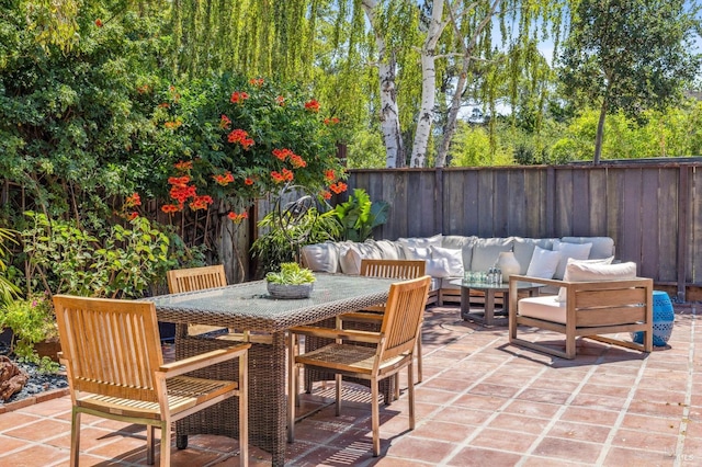 view of patio with an outdoor hangout area, outdoor dining space, and a fenced backyard