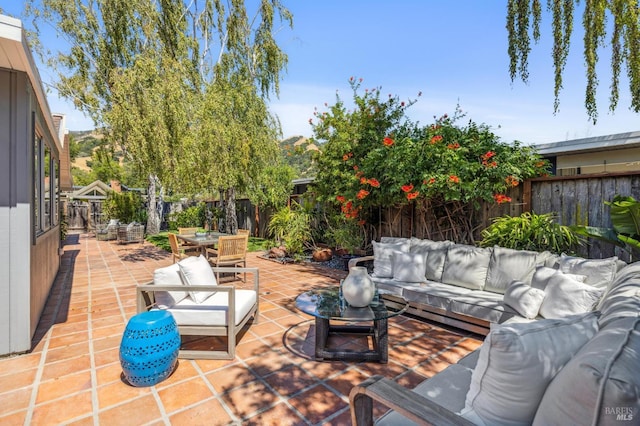 view of patio featuring outdoor dining area, a fenced backyard, and an outdoor hangout area