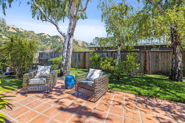 view of patio / terrace featuring a fenced backyard and a mountain view