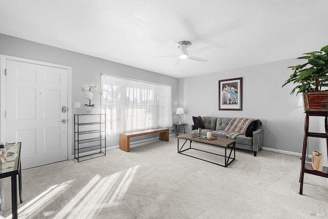 carpeted living room featuring ceiling fan