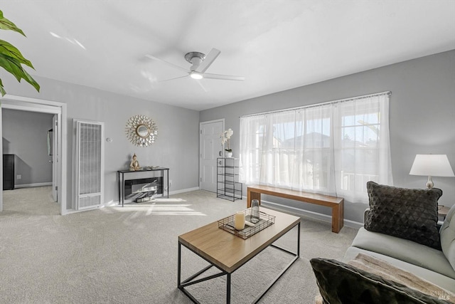 carpeted living room with ceiling fan