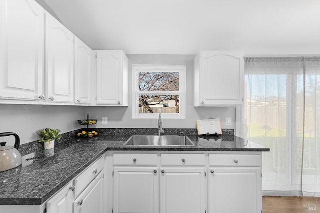 kitchen featuring plenty of natural light, sink, and white cabinets