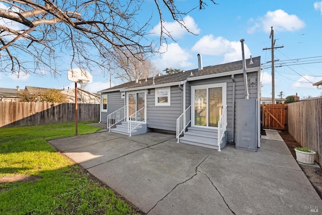 rear view of house featuring a patio area and a lawn