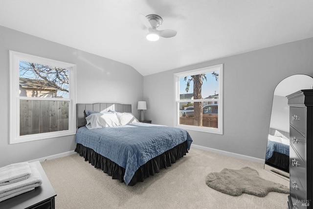 bedroom with ceiling fan, light colored carpet, and lofted ceiling