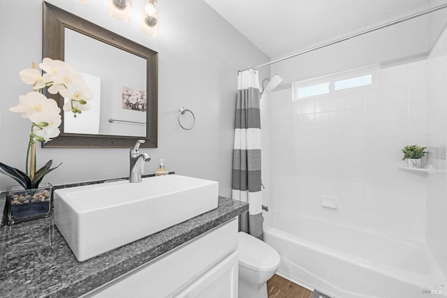 full bathroom with shower / tub combo with curtain, vanity, toilet, and hardwood / wood-style floors