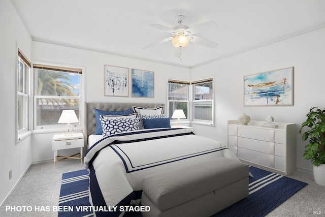 bedroom featuring ceiling fan and light carpet