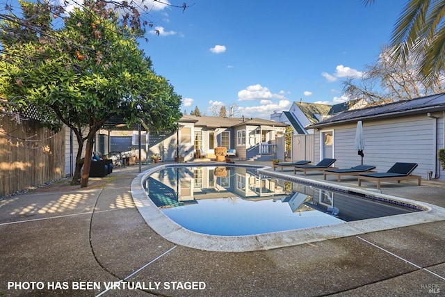 view of swimming pool featuring a patio area