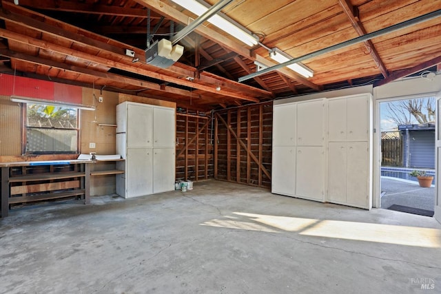 garage featuring a garage door opener and a workshop area