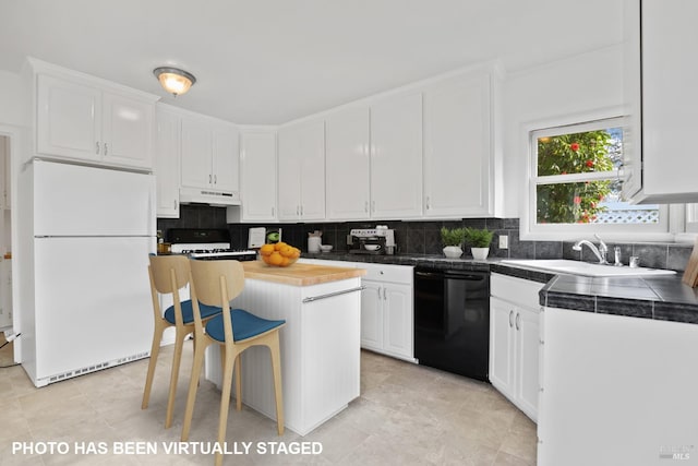 kitchen featuring range with gas cooktop, white cabinetry, dishwasher, a kitchen island, and white fridge