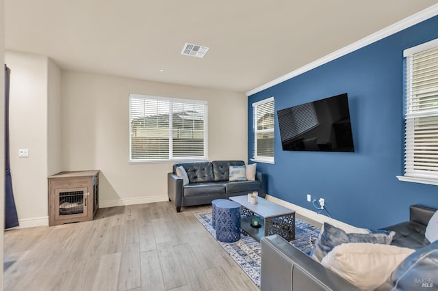 bedroom featuring crown molding, ceiling fan, and light hardwood / wood-style floors