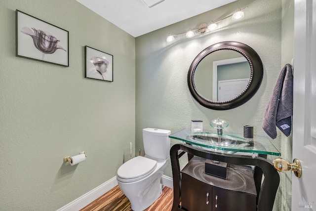 bathroom featuring vanity, hardwood / wood-style flooring, and toilet