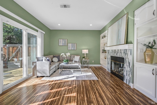 living room featuring dark hardwood / wood-style flooring and a wealth of natural light