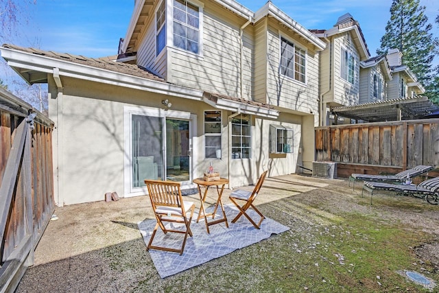 back of property with a patio