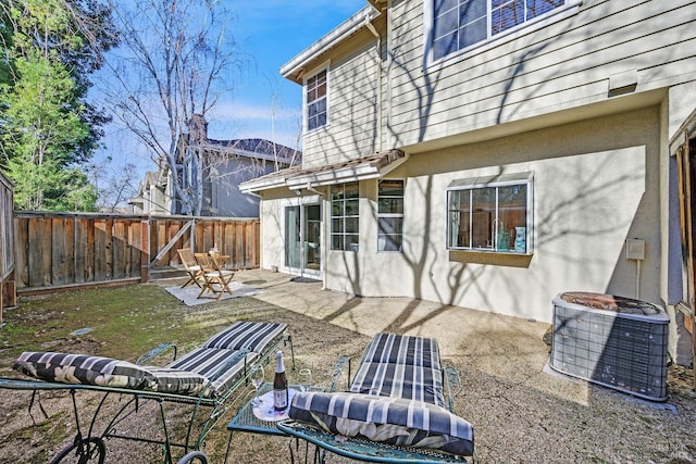 rear view of house with a patio and central AC