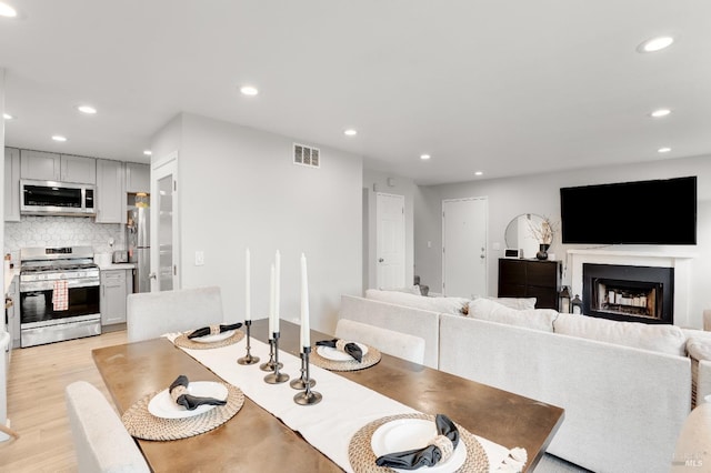 dining space featuring light wood-type flooring