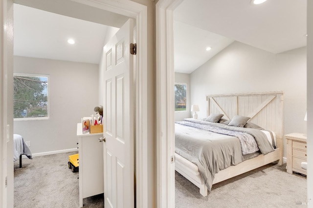 carpeted bedroom with lofted ceiling