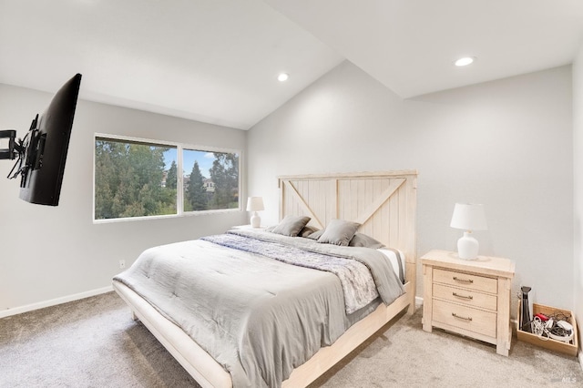 carpeted bedroom with lofted ceiling