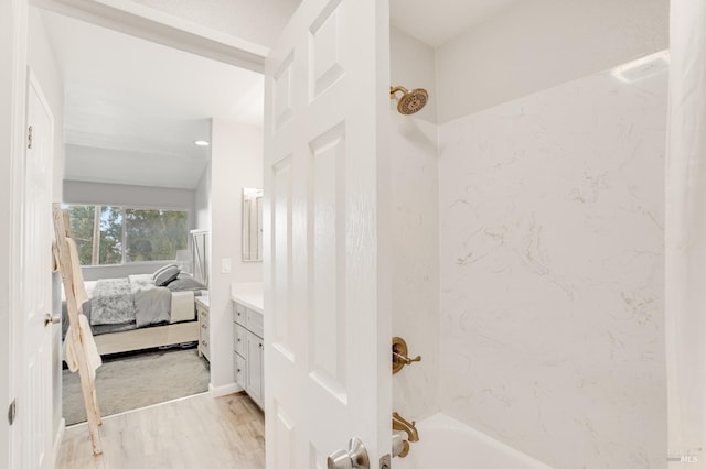 bathroom featuring vanity, hardwood / wood-style flooring, and shower / bathtub combination