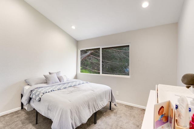 bedroom with lofted ceiling and carpet floors