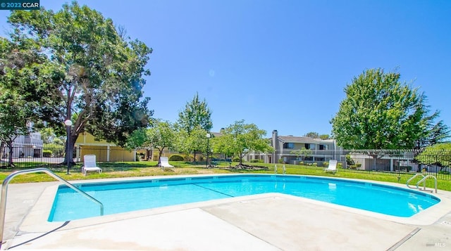 view of pool featuring a yard and a patio area