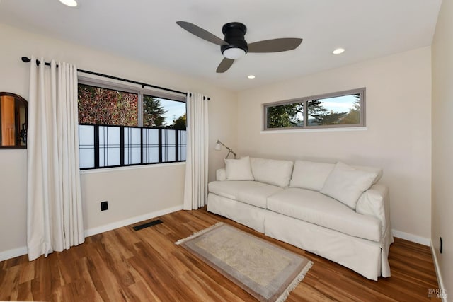 unfurnished living room featuring hardwood / wood-style flooring and ceiling fan